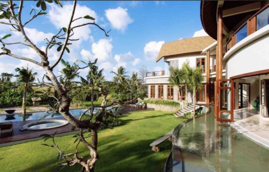 Garden area and swimming pool of villa during day