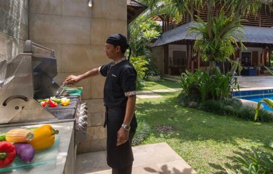 Bali staff cooking BBQ in villa