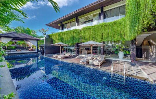 View of swimming pool and villa exterior at Villa Balimu in Seminyak