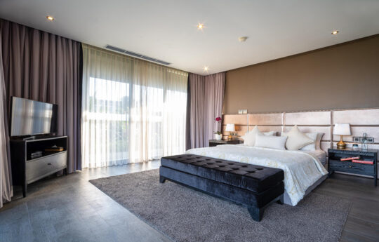 Luxury bedroom with TV and large bed