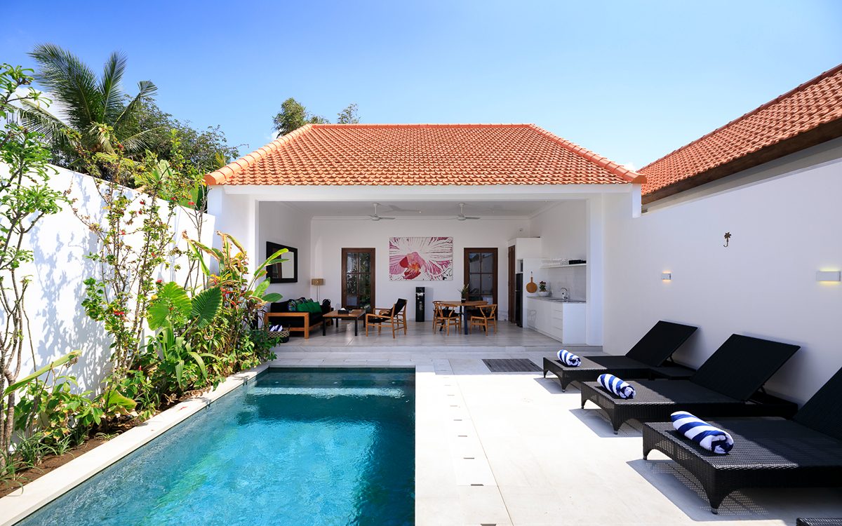 Villa views and swimming pool with day beds and deck area