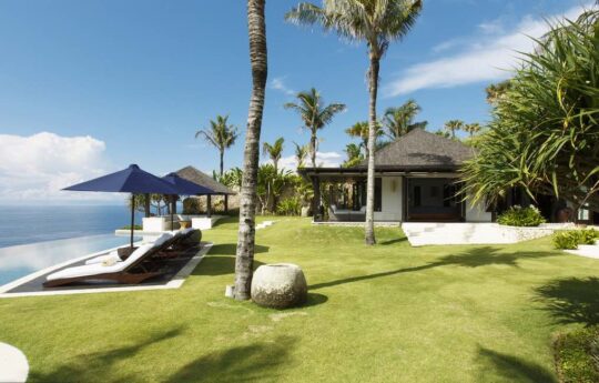 garden and pool area of villa with sunny swimming pool