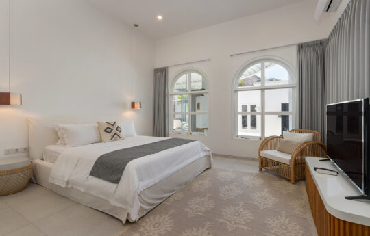 Modern bedroom of villa with TV and views to exterior