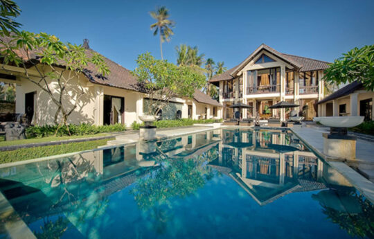 Villa exteriors and swimming pool on sunny day